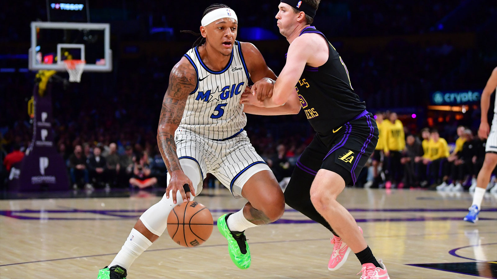 Orlando Magic forward Paolo Banchero (5) moves to the basket against Los Angeles Lakers guard Austin Reaves (15) during the first half at Crypto.com Arena.