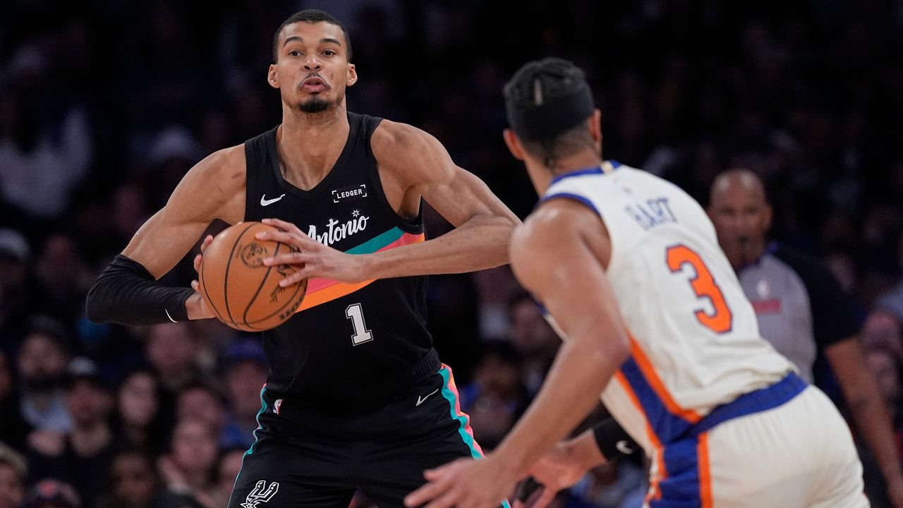 San Antonio Spurs' Victor Wembanyama, left, looks to pass around New York Knicks' Josh Hart (3) during the second half of an NBA basketball game Sunday, March 1, 2026, in New York. (AP Photo/Seth Wenig)