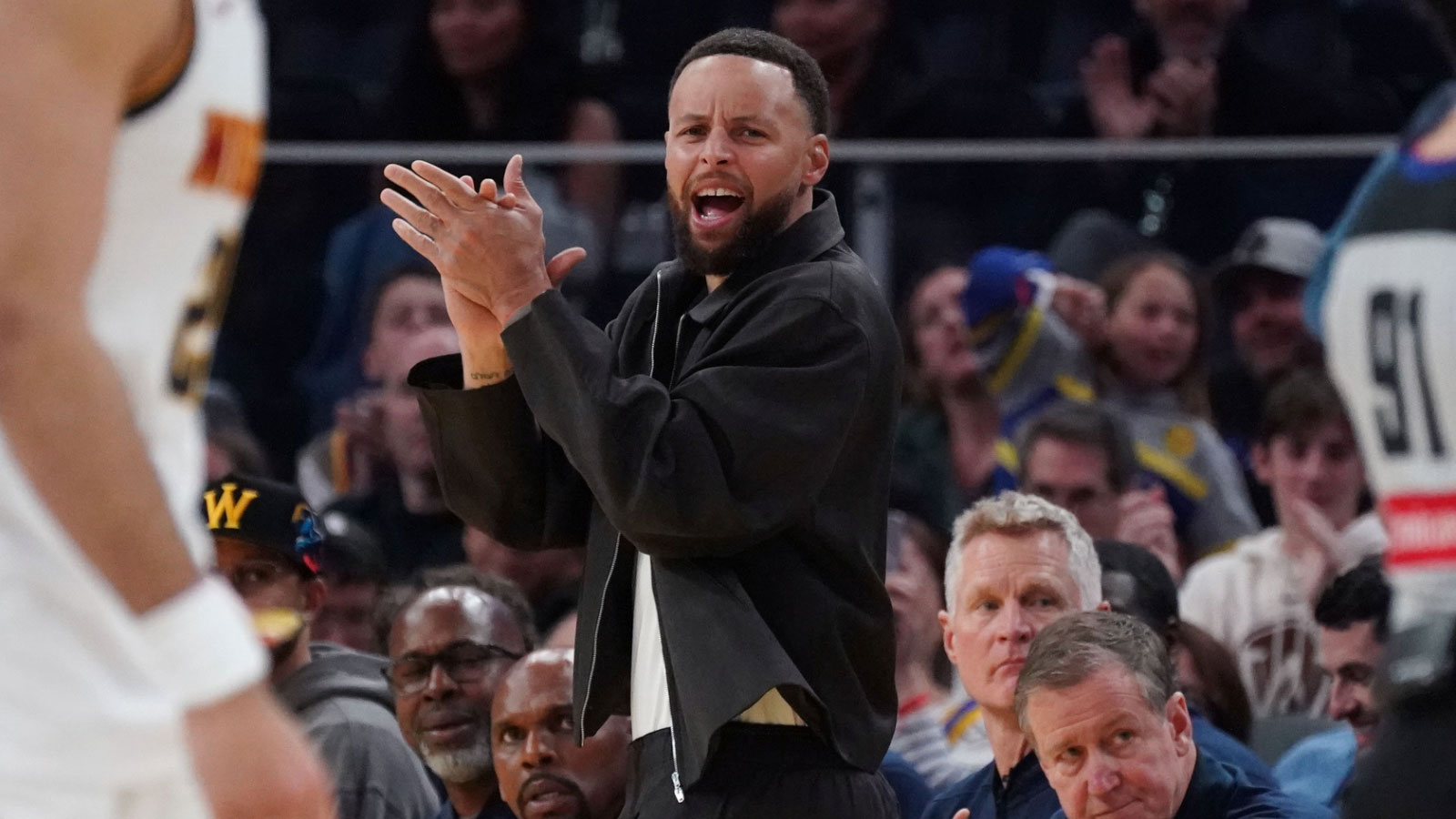 Golden State Warriors guard Stephen Curry (30) cheers from the bench during a game against the Denver Nuggets in the third quarter at Chase Center. 