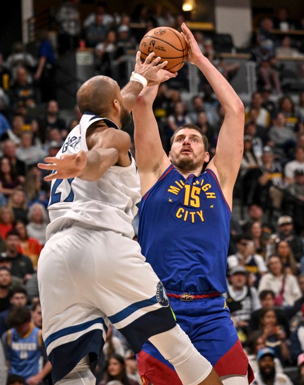 Nikola Jokic (15) of the Denver Nuggets shoots over Rudy Gobert (27) of the Minnesota Timberwolves during the third quarter at Ball Arena in Denver on Sunday, March 1, 2026. (Photo by AAron Ontiveroz/The Denver Post)