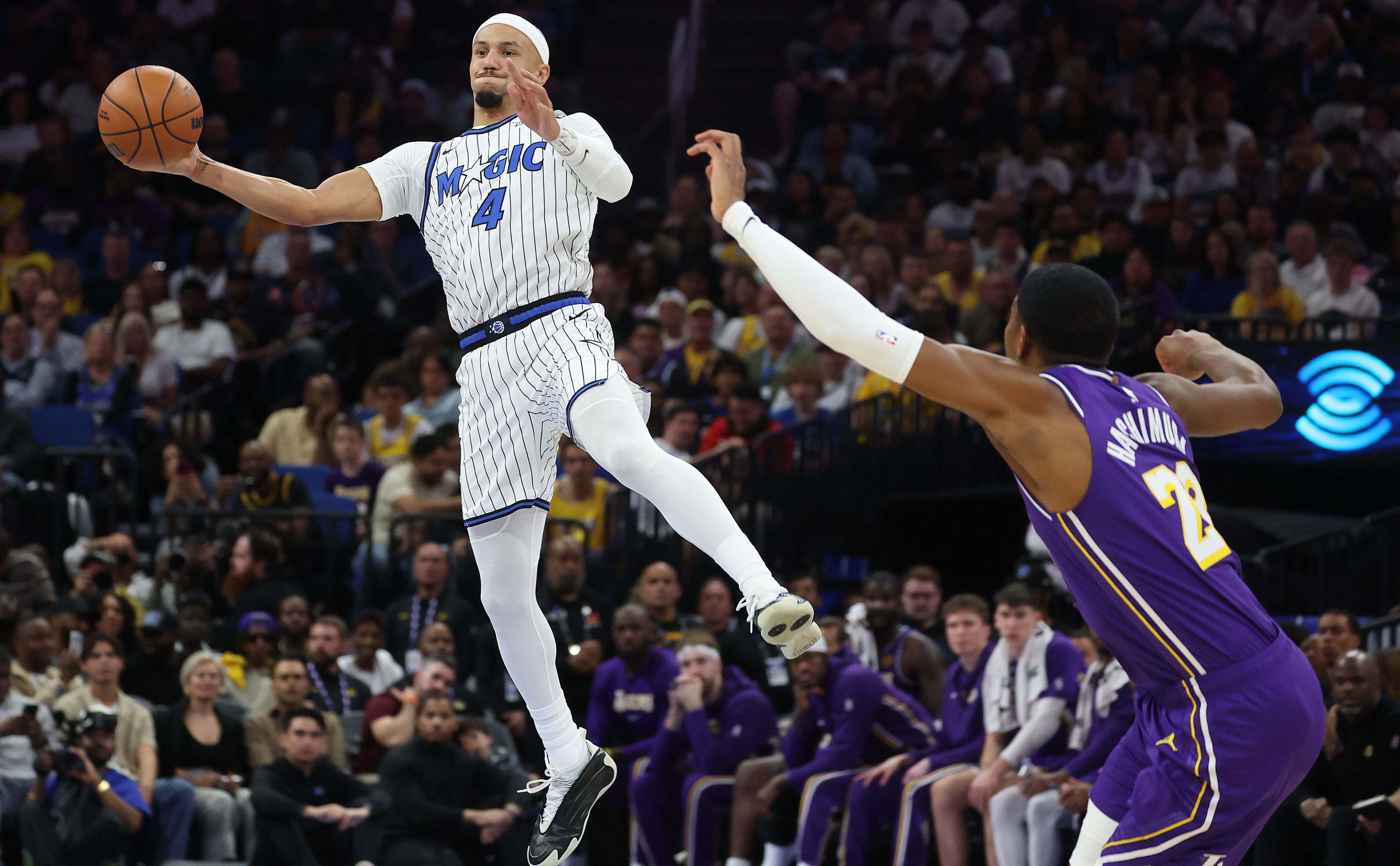 Orlando guard Jalen Suggs (4) leaps to catch a pass...