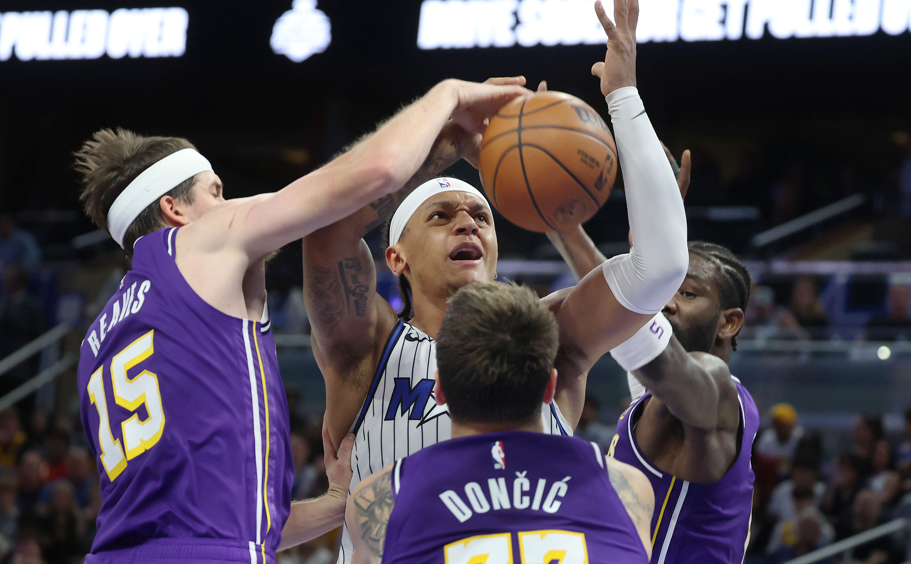 LA guard Austin Reaves (15) blocks a shot by Orlando...