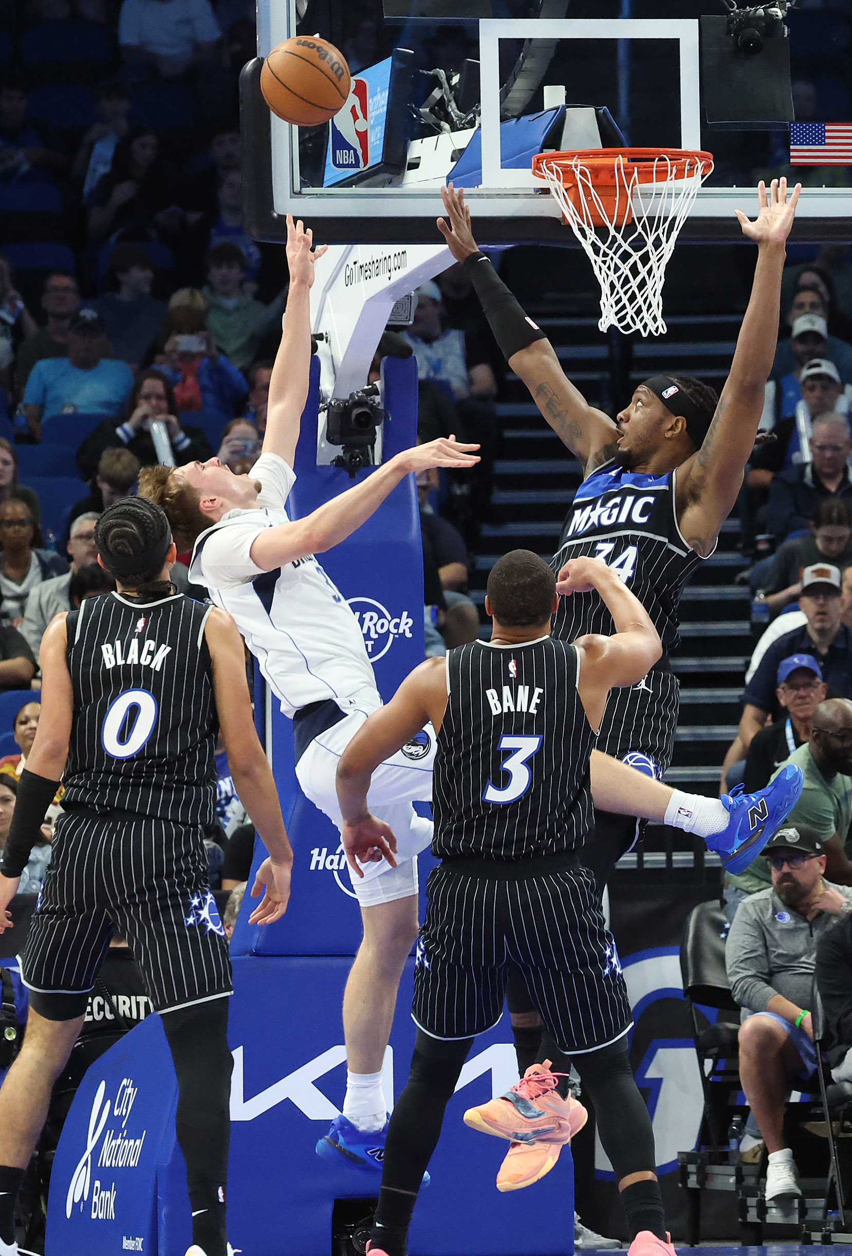 Dallas guard Cooper Flagg (white jersey) falls as he shoots...