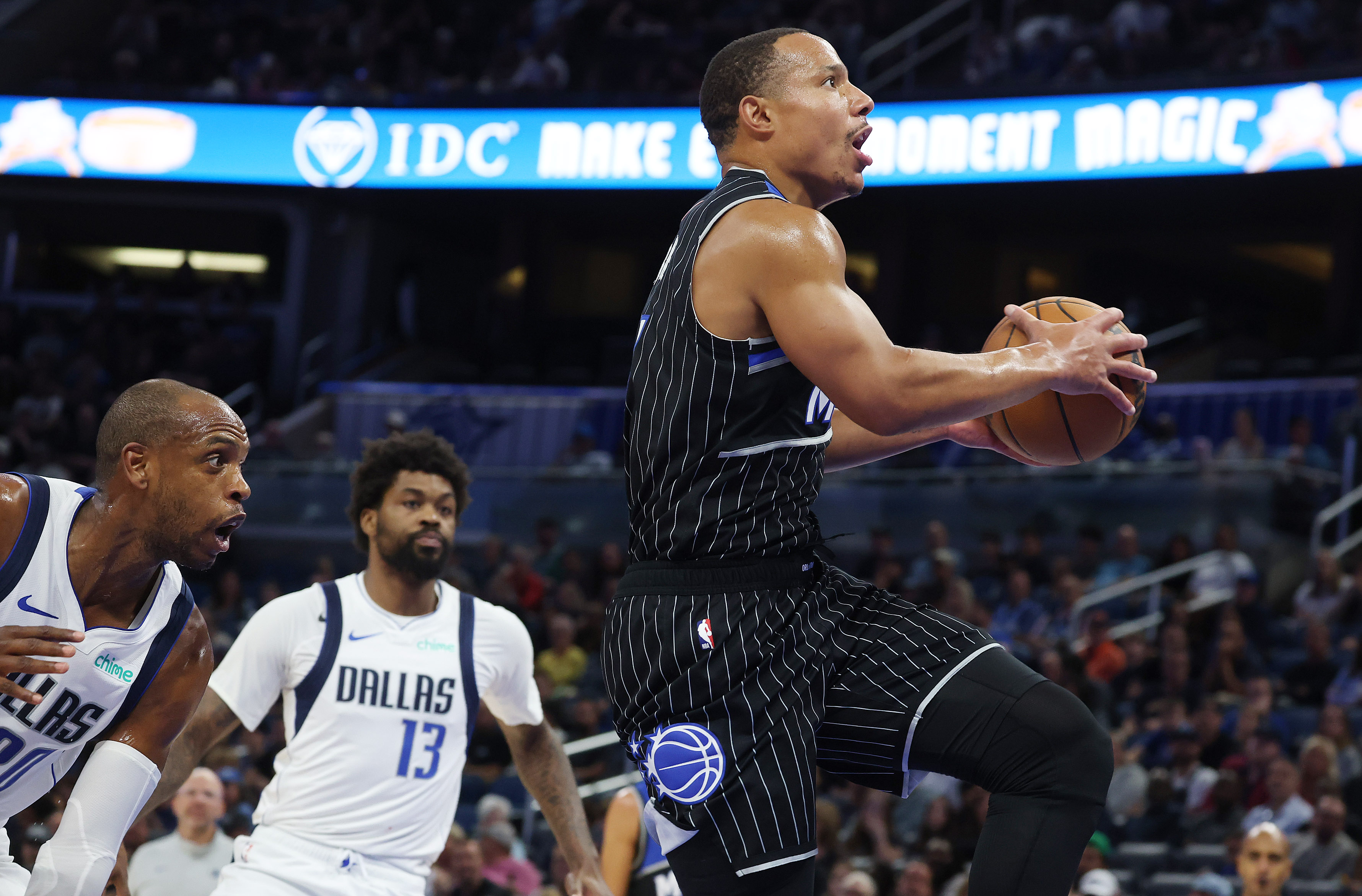 Orlando guard Desmond Bane (right) goes up for a layup...