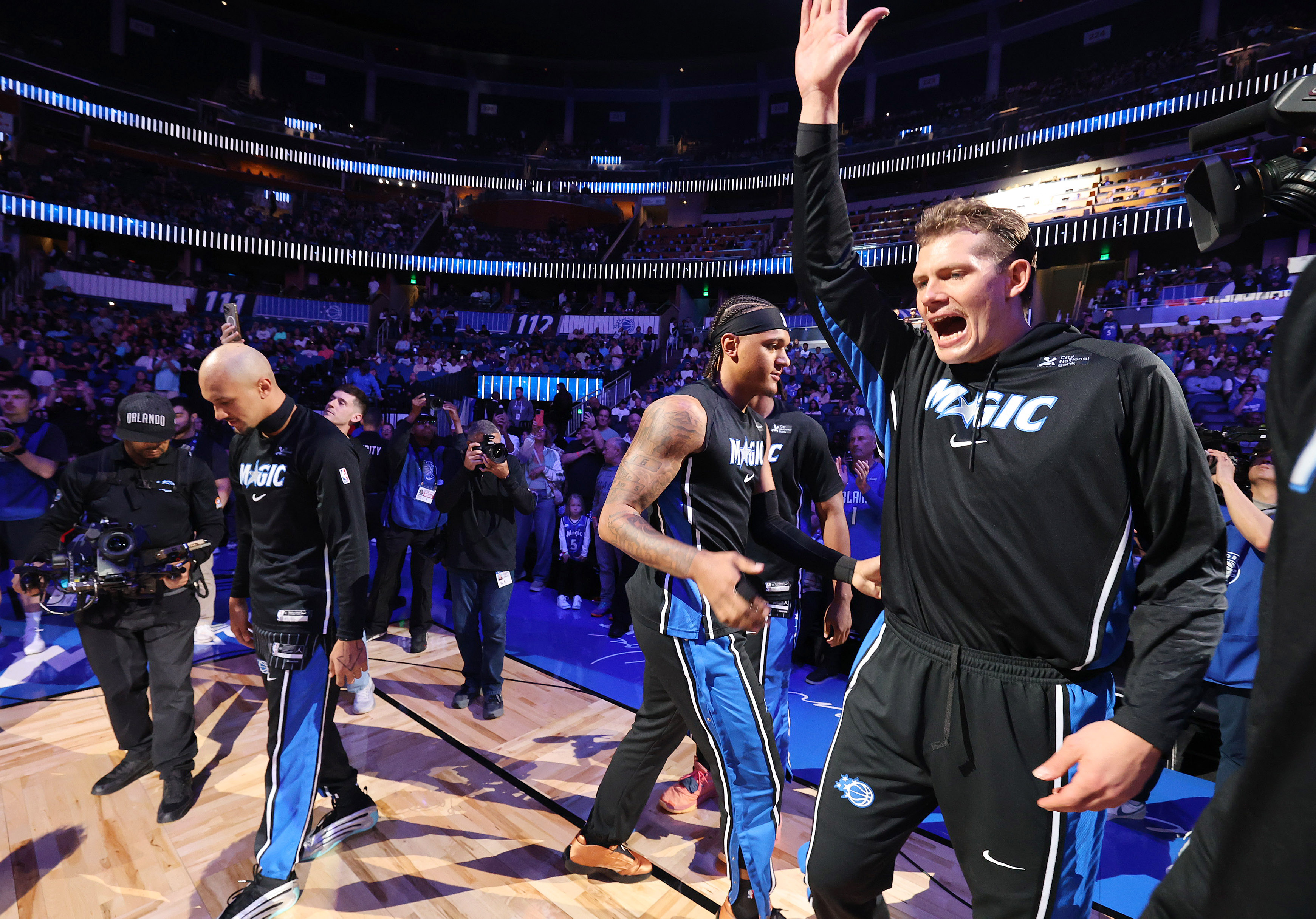 Orlando center Mo Wagner (left) and forward Paolo Banchero (second...