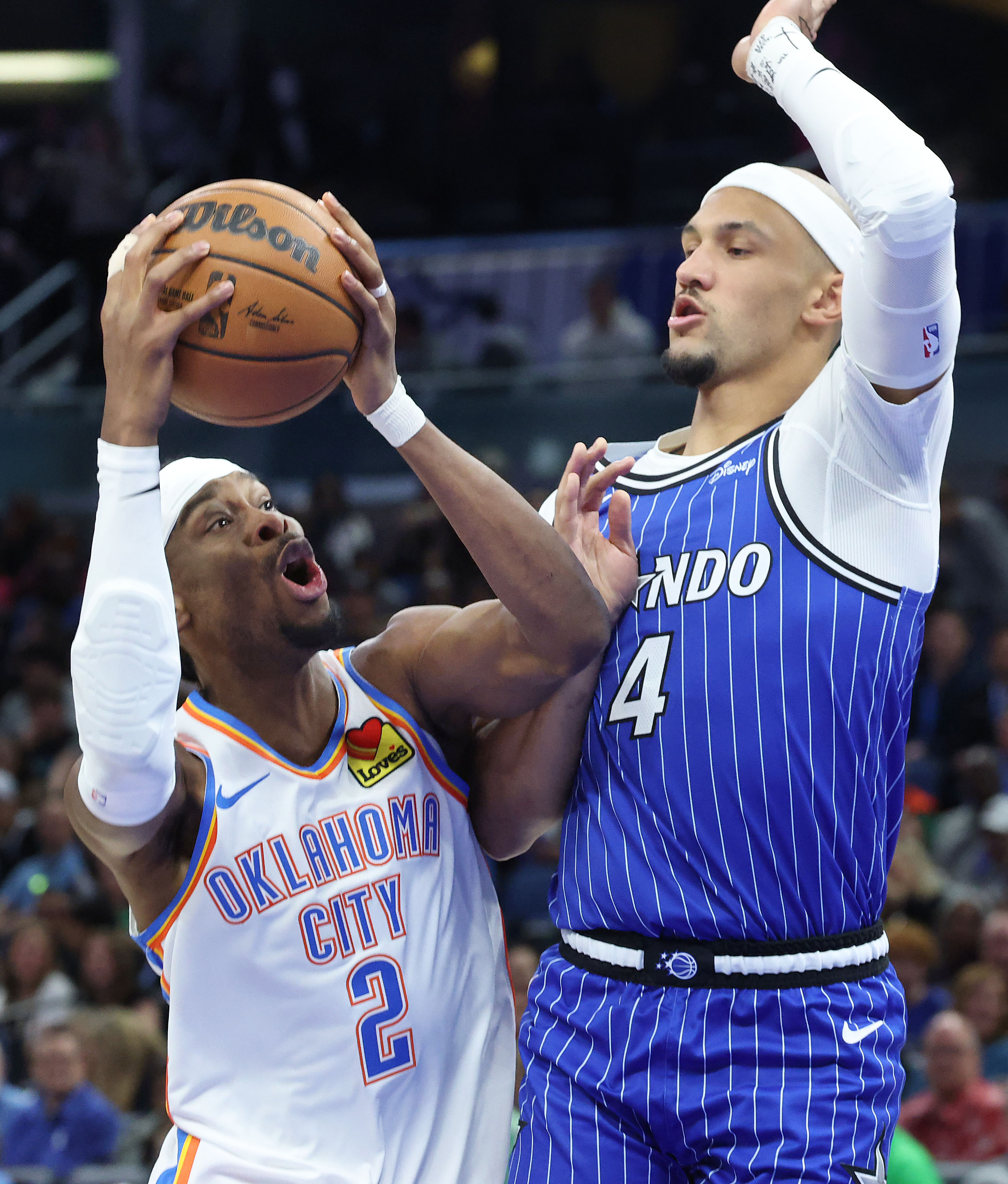 Thunder guard Shai Gilgeous-Alexander (2) tries to get past Orlando...