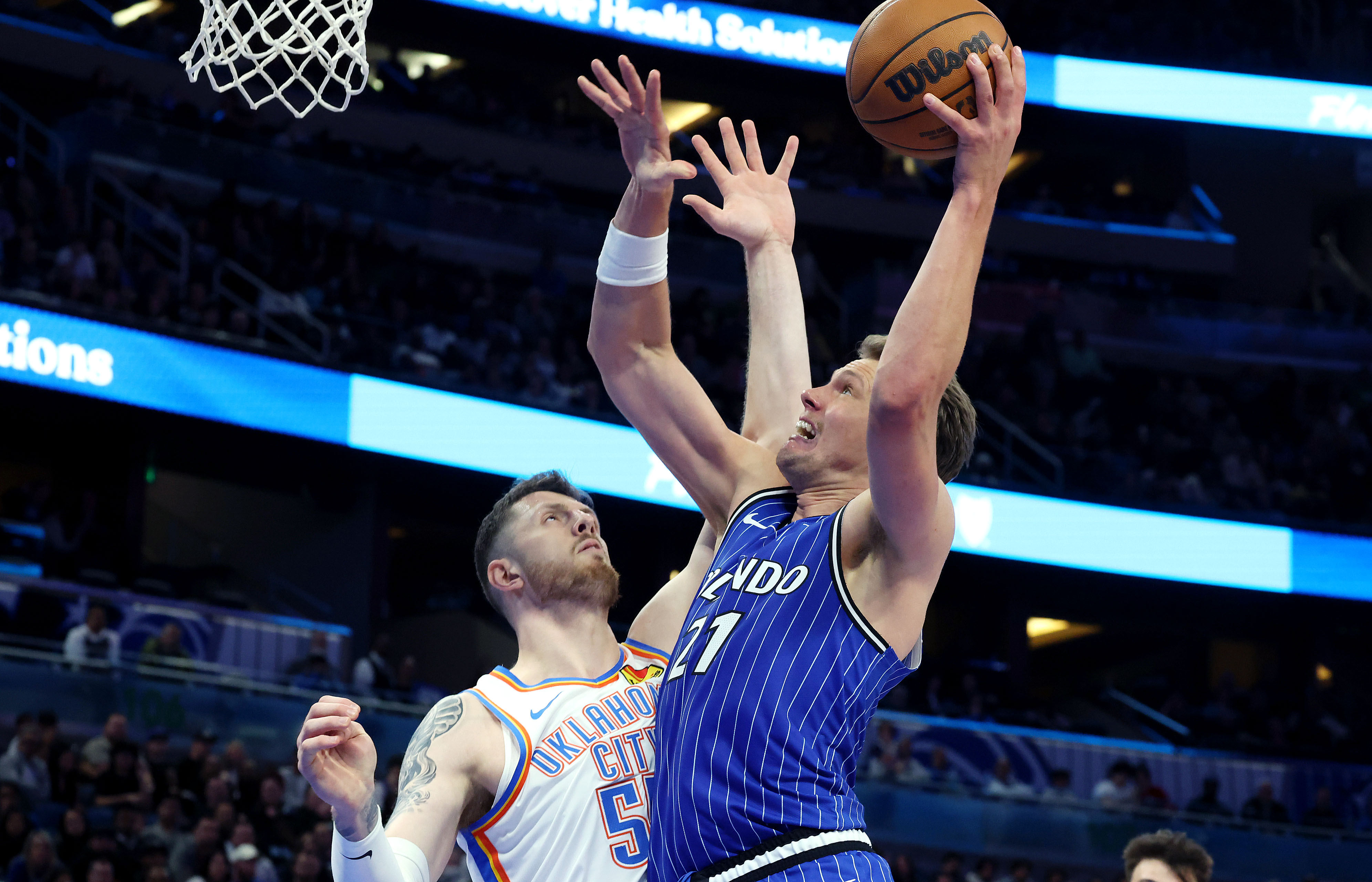 Magic center Mo Wagner (21) scores over Thunder center Isaiah...