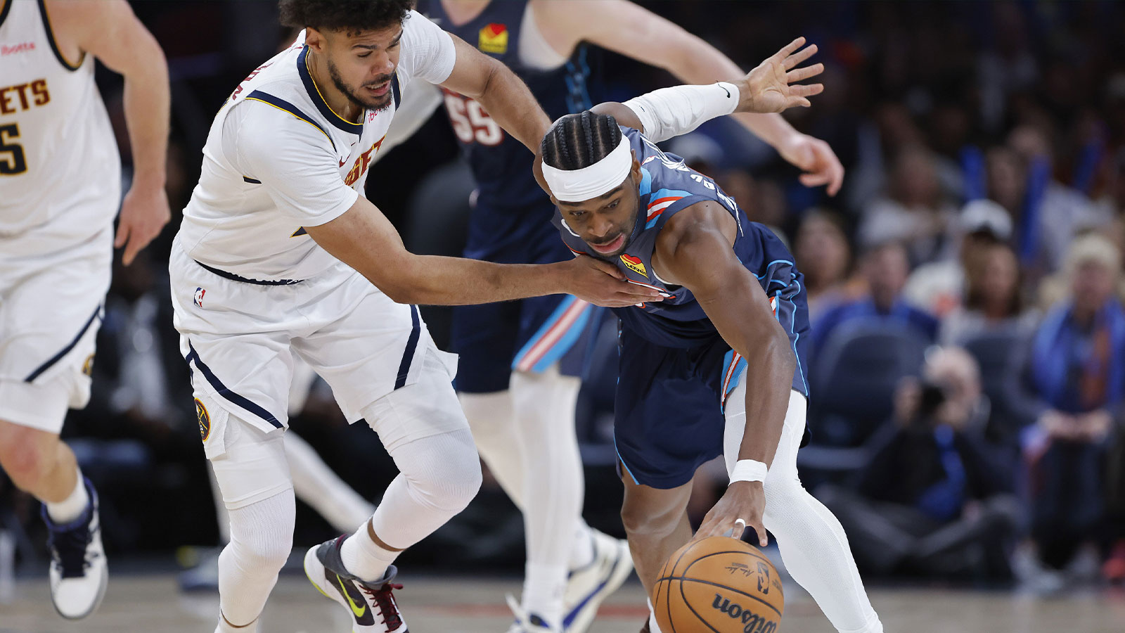 Nuggets forward Cameron Johnson (23) and Oklahoma City Thunder guard Shai Gilgeous-Alexander (2) fight for a loose ball during the third quarter at Paycom Center