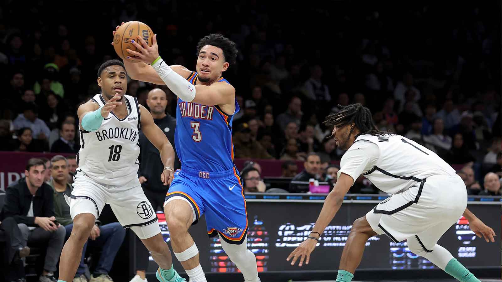 Thunder guard Jared McCain (3) drives to the basket against Brooklyn Nets guard Malachi Smith (18) and forward Ziaire Williams (1) during the first quarter at Barclays Center
