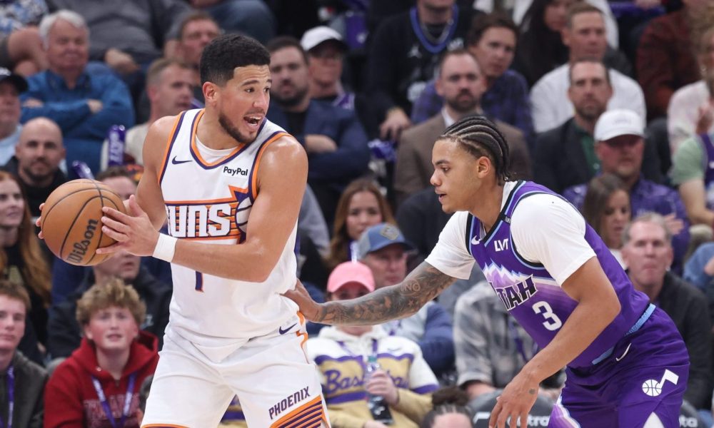 Oct 27, 2025; Salt Lake City, Utah, USA; Phoenix Suns guard Devin Booker (1) looks for the play against Utah Jazz guard Keyonte George (3) during the second half at Delta Center. Mandatory Credit: Rob Gray-Imagn Images