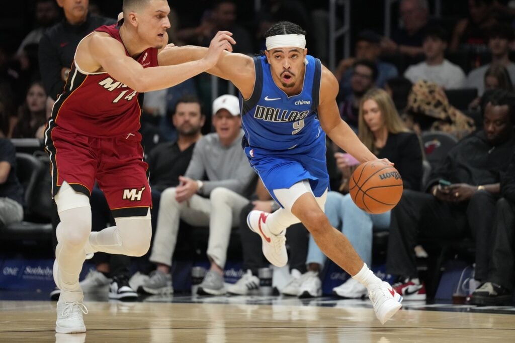 Nov 24, 2025; Miami, Florida, USA; Dallas Mavericks guard Ryan Nembhard (9) drives past Miami Heat guard Tyler Herro (14) during the second half at Kaseya Center. Mandatory Credit: Jim Rassol-Imagn Images