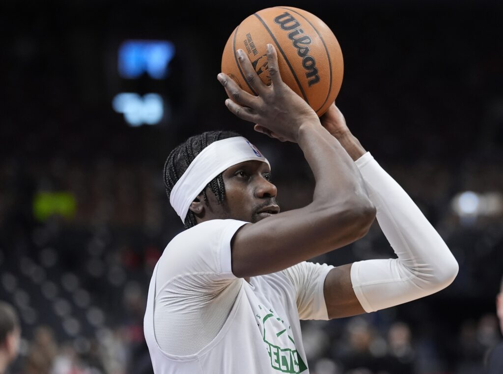Boston Celtics center Chris Boucher (99) goes to shoot a basket during warm up before a game against the Toronto Raptors at Scotiabank Arena.
