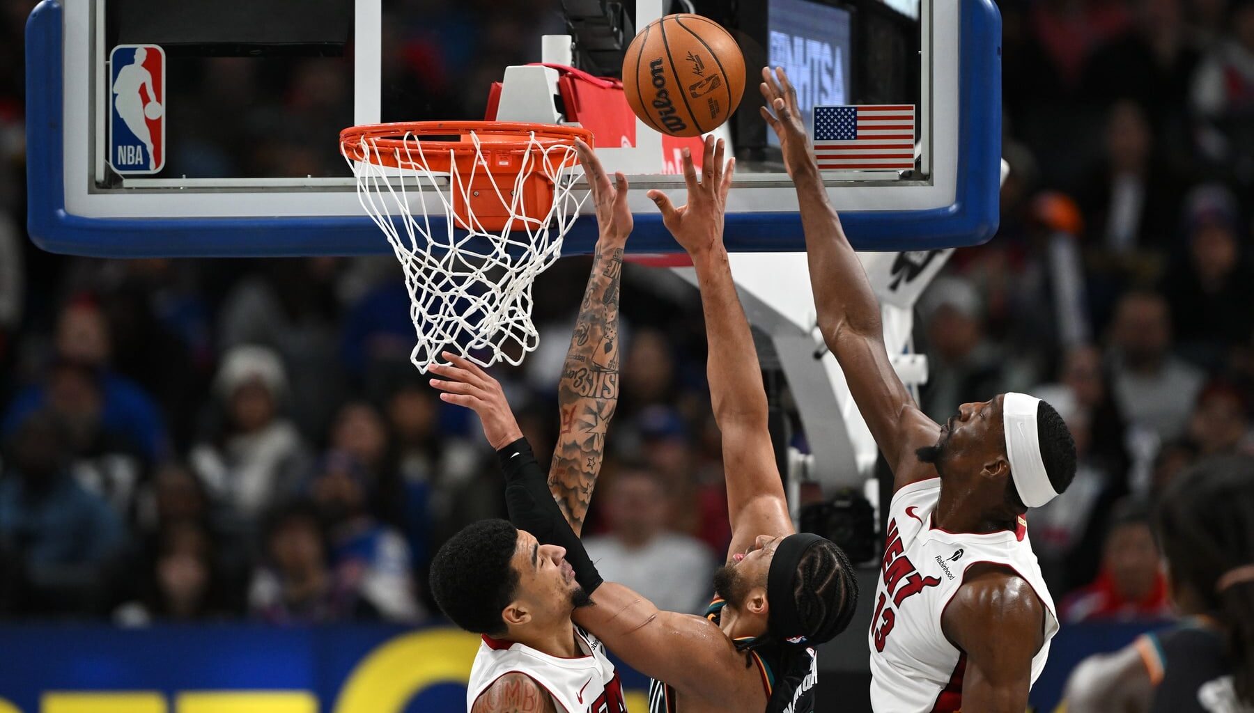 Jan 1, 2026; Detroit, Michigan, USA; Detroit Pistons guard Cade Cunningham (2) shoots the ball between Miami Heat centers Kel'El Ware (left) and Bam Adebayo (13) in the third quarter at Little Caesars Arena. Mandatory Credit: Lon Horwedel-Imagn Images