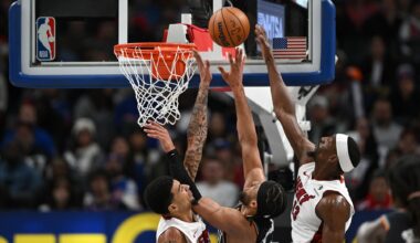 Jan 1, 2026; Detroit, Michigan, USA; Detroit Pistons guard Cade Cunningham (2) shoots the ball between Miami Heat centers Kel'El Ware (left) and Bam Adebayo (13) in the third quarter at Little Caesars Arena. Mandatory Credit: Lon Horwedel-Imagn Images