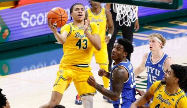 Feb 10, 2026; Waco, Texas, USA; Baylor Bears guard Cameron Carr (43) drives to the basket for a layup past BYU Cougars guard Robert Wright III (1) during the second half at Paul and Alejandra Foster Pavilion. Mandatory Credit: Chris Jones-Imagn Images