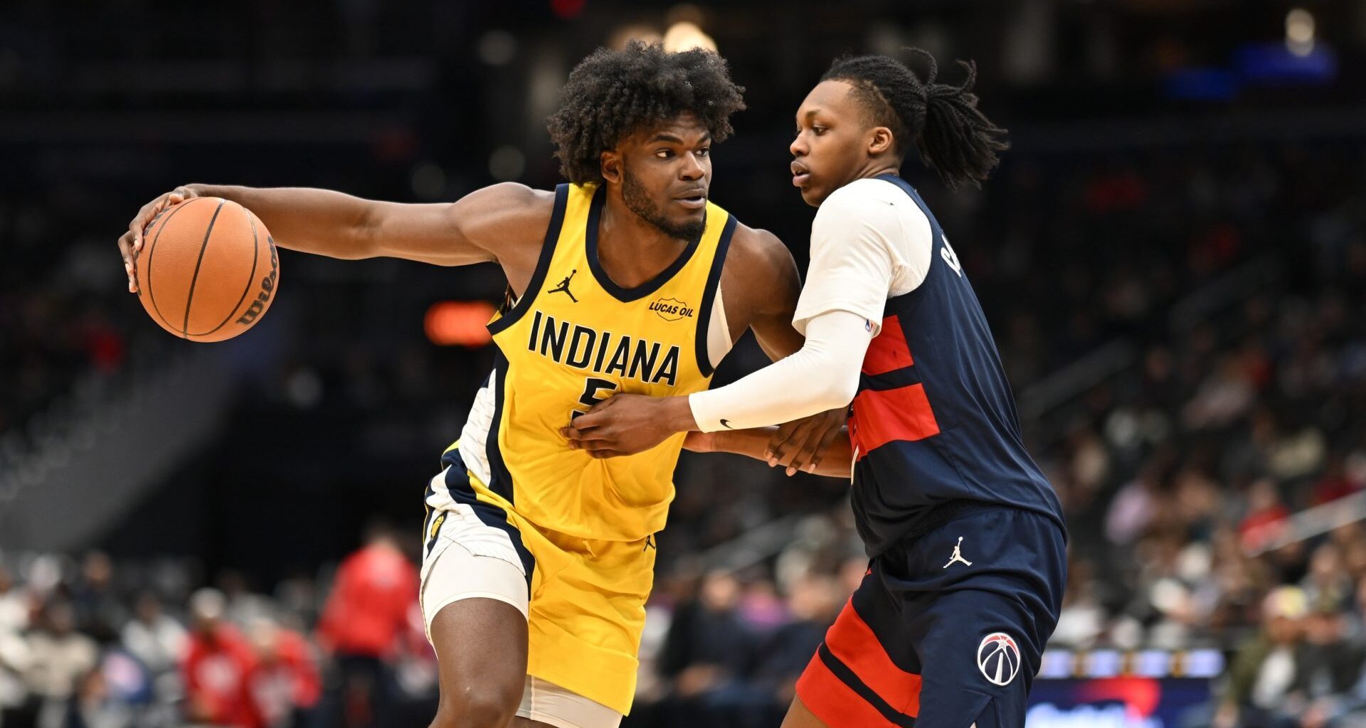 Feb 20, 2026; Washington, District of Columbia, USA; Indiana Pacers forward Jarace Walker (5) drives against Washington Wizards guard Bub Carrington (7) during the fourth quarter at Capital One Arena.