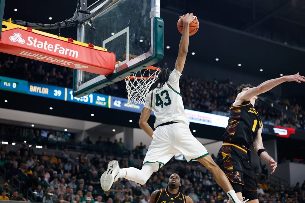 Feb 21, 2026; Waco, Texas, USA; Baylor Bears guard Cameron Carr (43) dunks the ball against Arizona State Sun Devils forward Santiago Trouet (1) during the second half at Paul and Alejandra Foster Pavilion. Mandatory Credit: Chris Jones-Imagn Images