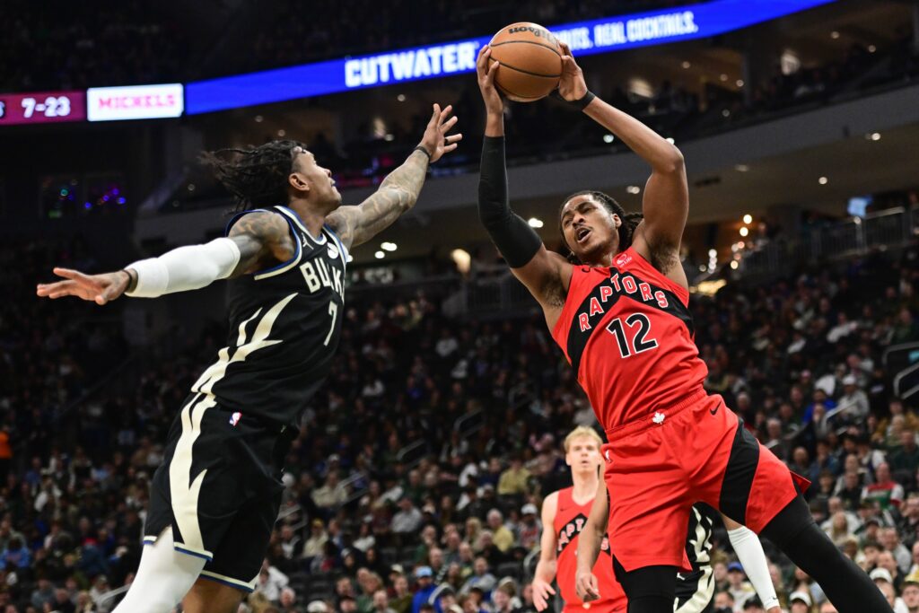 Toronto Raptors forward Collin Murray-Boyles (12) grabs a rebound against Milwaukee Bucks guard Kevin Porter (7) in the first quarter at Fiserv Forum.