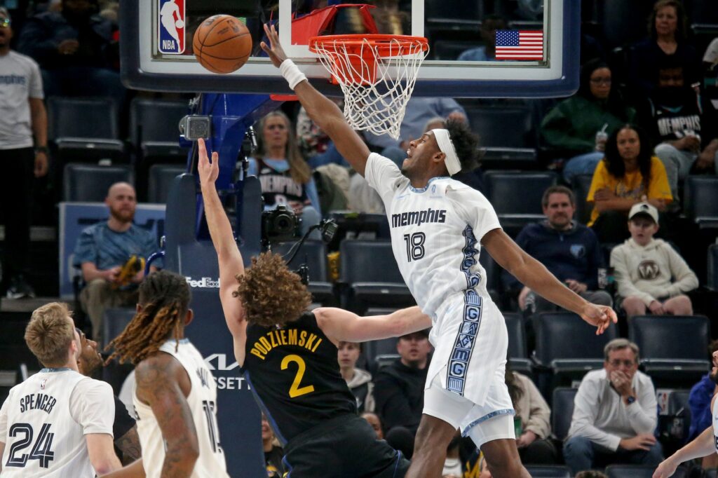 Feb 25, 2026; Memphis, Tennessee, USA; Memphis Grizzlies forward Olivier-Maxence Prosper (18) defends as Golden State Warriors guard Brandin Podziemski (2) shoots during the second quarter at FedExForum. Mandatory Credit: Petre Thomas-Imagn Images