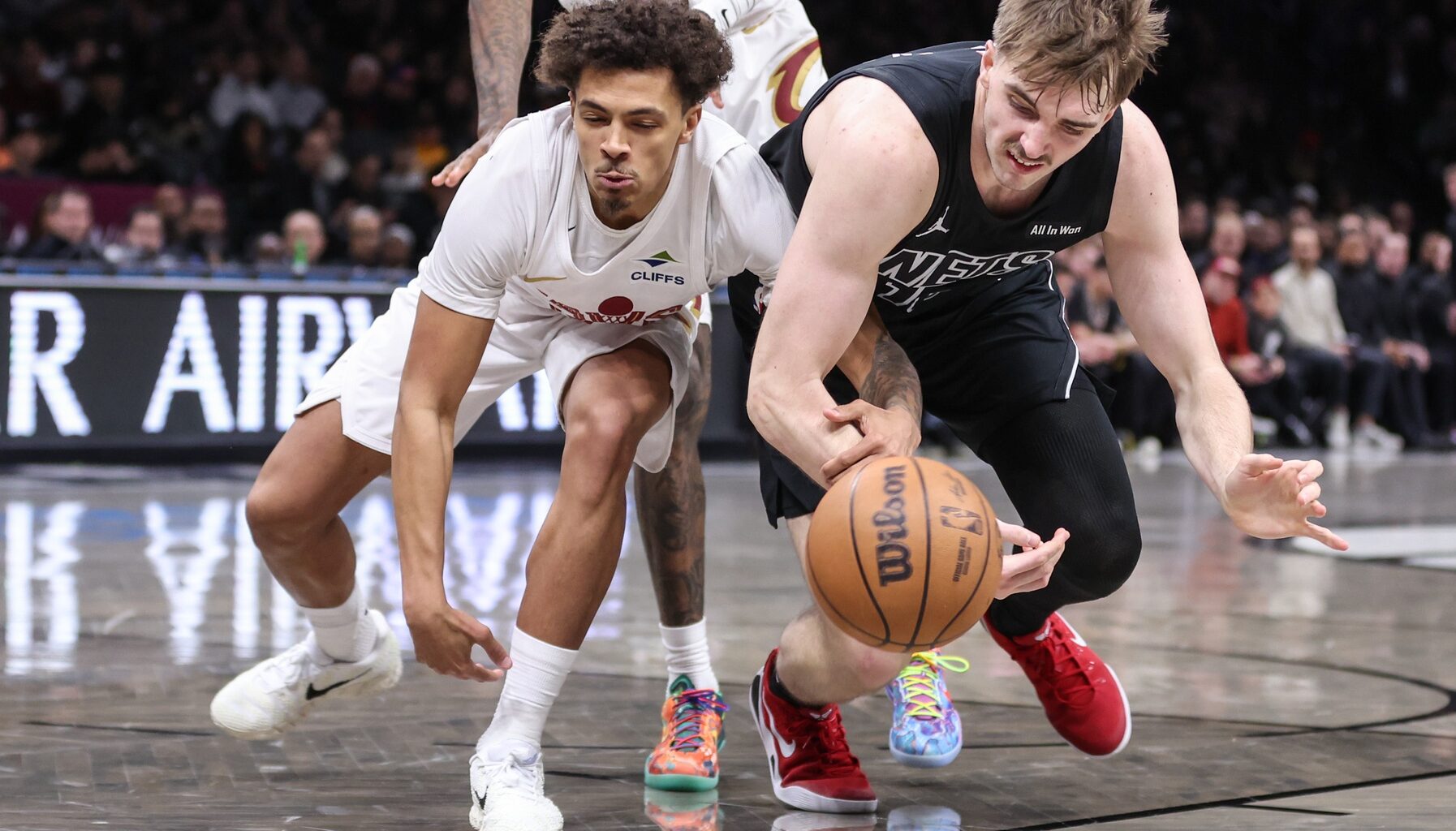 Mar 1, 2026; Brooklyn, New York, USA; Cleveland Cavaliers guard Craig Porter Jr. (9) and Brooklyn Nets forwrd Grant Nelson (16) fight for a loose ball in the third quarter at Barclays Center.
