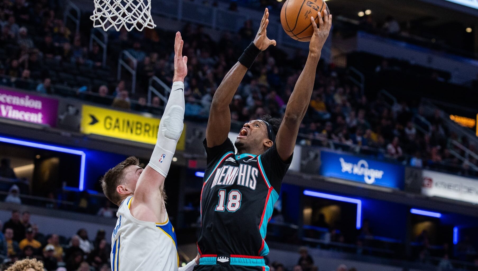 Mar 1, 2026; Indianapolis, Indiana, USA; Memphis Grizzlies forward Olivier-Maxence Prosper (18) shoots the ball while Indiana Pacers center Micah Potter (11) defends in the second half at Gainbridge Fieldhouse. Mandatory Credit: Trevor Ruszkowski-Imagn Images