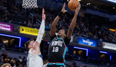 Mar 1, 2026; Indianapolis, Indiana, USA; Memphis Grizzlies forward Olivier-Maxence Prosper (18) shoots the ball while Indiana Pacers center Micah Potter (11) defends in the second half at Gainbridge Fieldhouse. Mandatory Credit: Trevor Ruszkowski-Imagn Images
