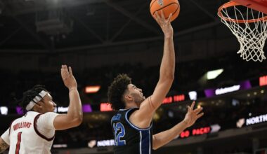 Mar 2, 2026; Raleigh, North Carolina, USA; Duke Blue Devils forward Cameron Boozer (12) lays the ball up against NC State Wolfpack forward Darrion Williams (1) during the second half at Lenovo Center. Mandatory Credit: Zachary Taft-Imagn Images
