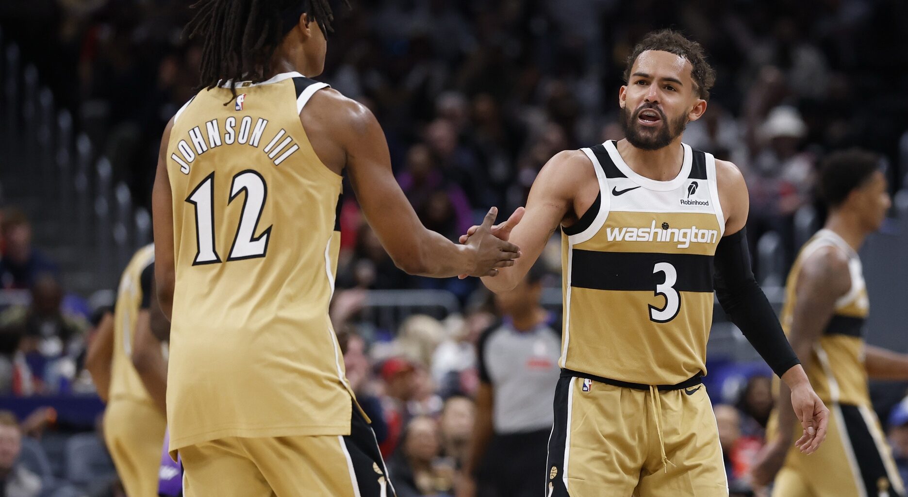 Mar 5, 2026; Washington, District of Columbia, USA; Washington Wizards guard Trae Young (3) celebrates with Wizards guard Tre Johnson (12) after a base against the Utah Jazz in the second half at Capital One Arena. Mandatory Credit: Geoff Burke-Imagn Images