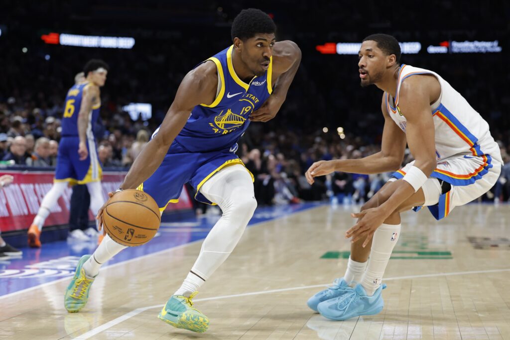 Mar 7, 2026; Oklahoma City, Oklahoma, USA; Golden State Warriors guard Nate Williams (19) moves the ball around Oklahoma City Thunder guard Aaron Wiggins (21) during the second half at Paycom Center. Mandatory Credit: Alonzo Adams-Imagn Images