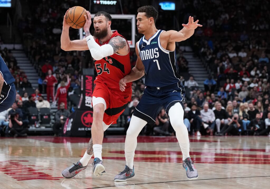Toronto Raptors forward Sandro Mamukelashvili (54) controls the ball as Dallas Mavericks forward Dwight Powell (7) tries to defend during the fourth quarter at Scotiabank Arena.