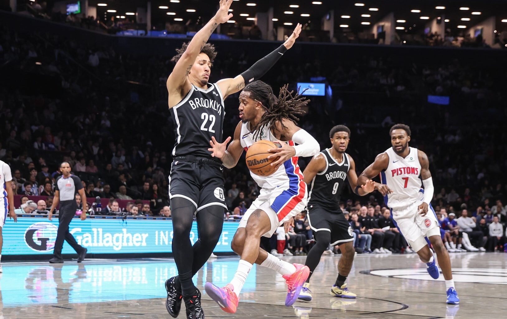 Mar 10, 2026; Brooklyn, New York, USA; Detroit Pistons guard Daniss Jenkins (24) drives past Brooklyn Nets forward Jalen Wilson (22) in the fourth quarter at Barclays Center. Mandatory Credit: Wendell Cruz-Imagn Images