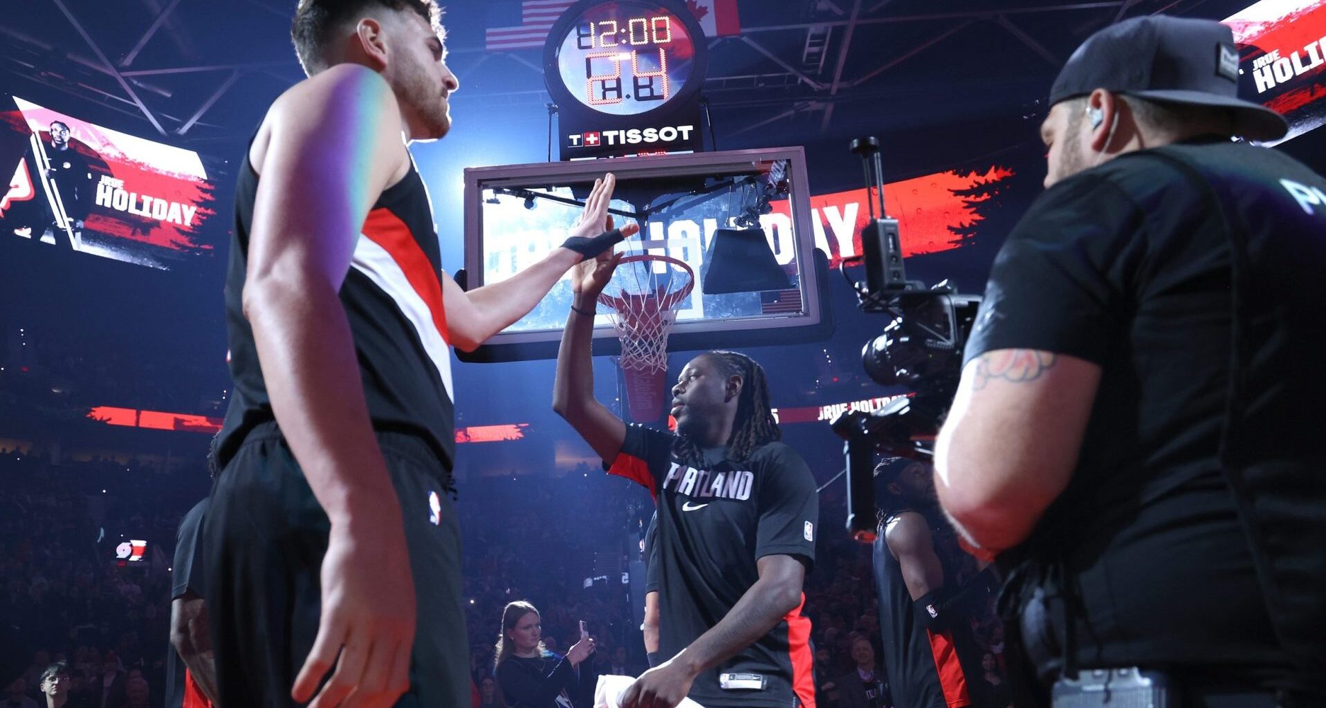 Mar 13, 2026; Portland, Oregon, USA; Portland Trail Blazers center Donovan Clingan (23) high-fives guard Jrue Holiday (5) while entering the line up to play against the Utah Jazz at Moda Center.