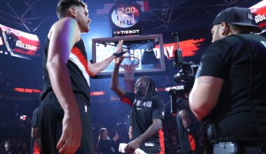 Mar 13, 2026; Portland, Oregon, USA; Portland Trail Blazers center Donovan Clingan (23) high-fives guard Jrue Holiday (5) while entering the line up to play against the Utah Jazz at Moda Center.