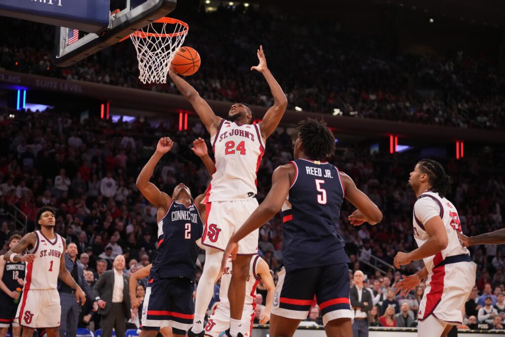 St. John's Red Storm forward Zuby Ejiofor (24) grabs the rebound over Connecticut Huskies guard Silas Demary Jr. (2) during the second half of the men's Big East Conference Tournament Championship at Madison Square Garden.