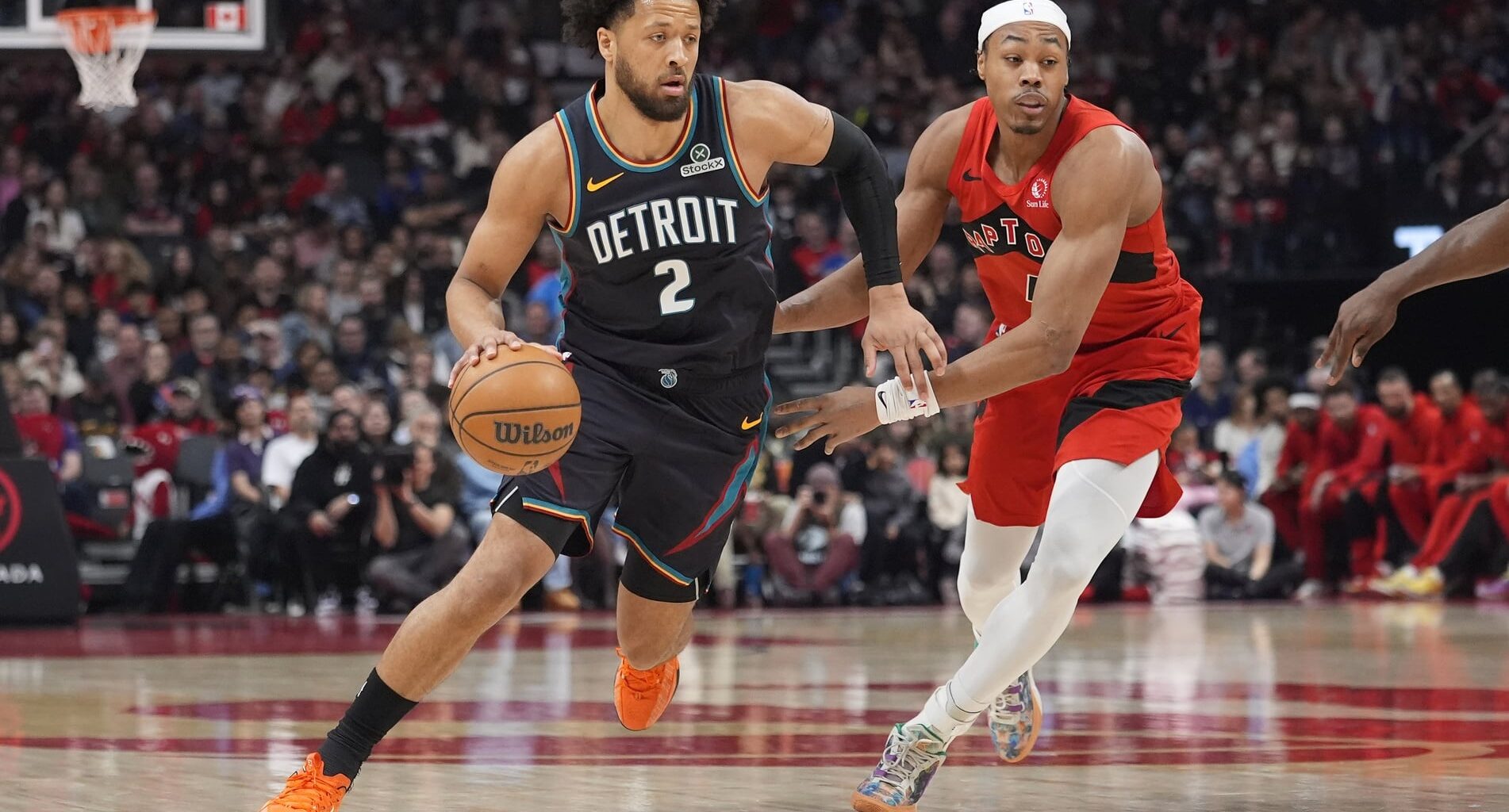 Detroit Pistons guard Cade Cunningham (2) drives to the basket against Toronto Raptors guard Scottie Barnes (4) during the first half at Scotiabank Arena.