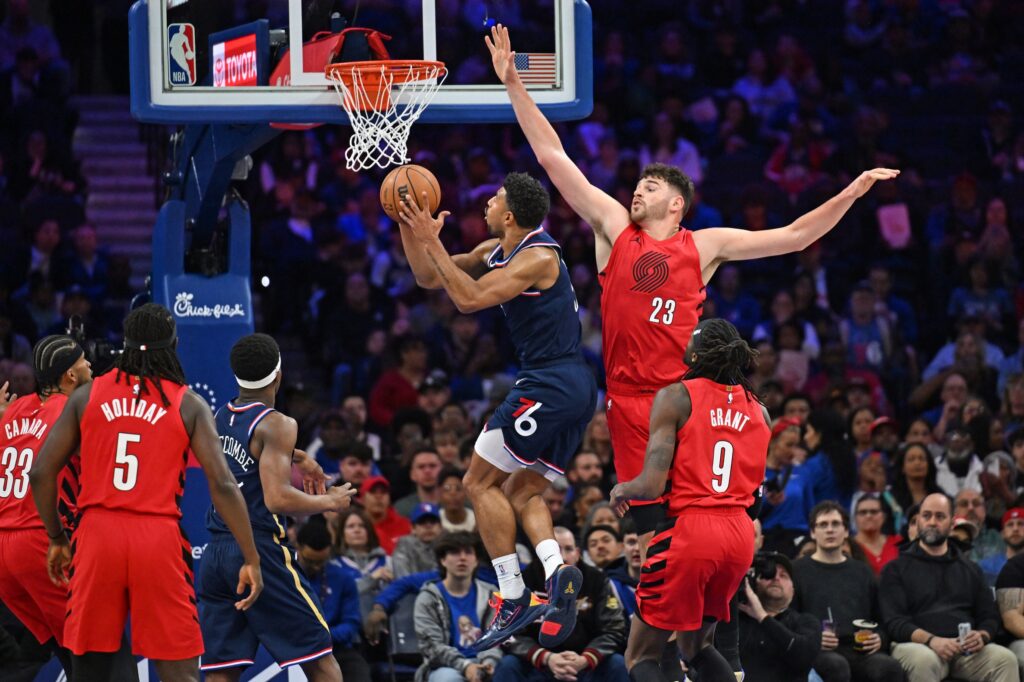 Philadelphia 76ers guard Quentin Grimes (5) lays up past Portland Trail Blazers center Donovan Clingan (23) during the first half at Xfinity Mobile Arena.