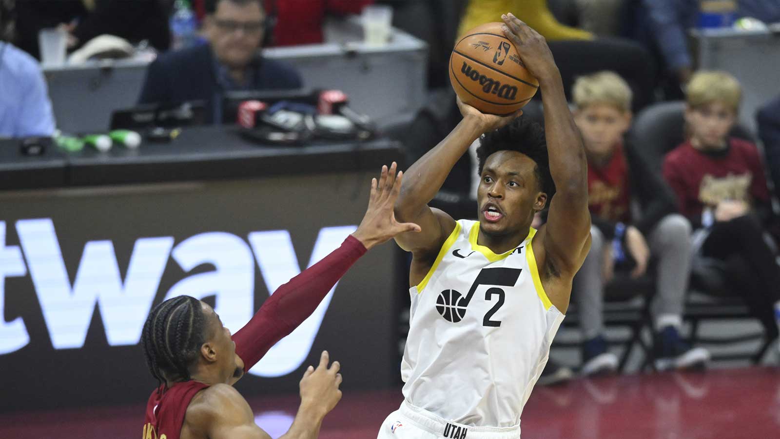 Dec 20, 2023; Cleveland, Ohio, USA; Utah Jazz guard Collin Sexton (2) shoots as Cleveland Cavaliers forward Isaac Okoro (35) defends in the first quarter at Rocket Mortgage FieldHouse. Mandatory Credit: David Richard-Imagn Images