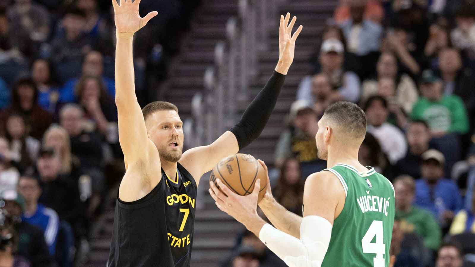 Golden State Warriors center Kristaps Porzingis (7) guards Boston Celtics center Nikola Vucevic (4) during the third quarter at Chase Center. 