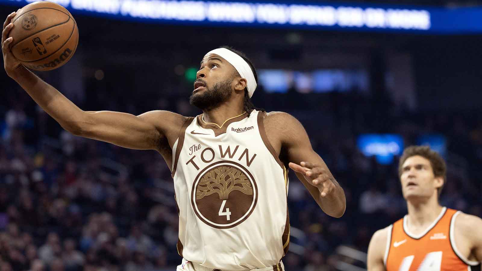 Golden State Warriors guard Moses Moody (4) lays the ball up ahead of Los Angeles Clippers center Brook Lopez (11) during the first quarter at Chase Center.