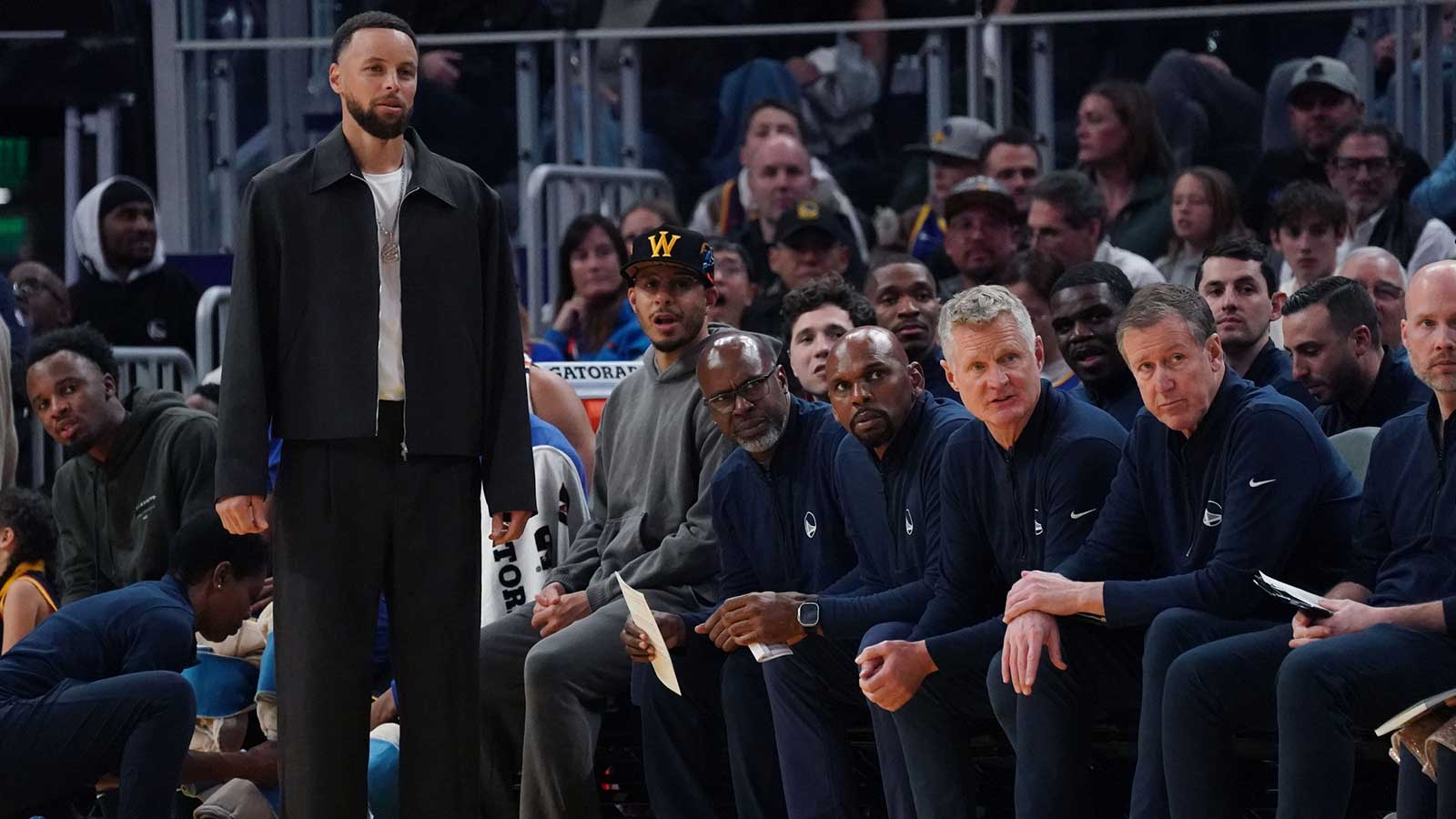 Golden State Warriors guard Stephen Curry (30) watches from the bench in the third quarter during a game against the Denver Nuggets at Chase Center.