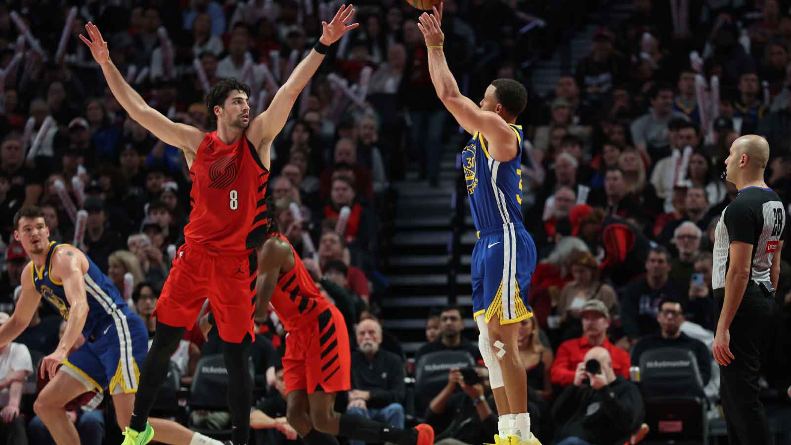 Golden State Warriors guard Stephen Curry (30) shoots the ball over Portland Trail Blazers forward Deni Avdija (8) during the second half at Moda Center.