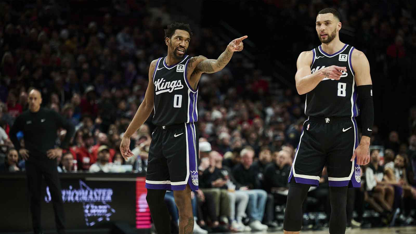 Feb 6, 2025; Portland, Oregon, USA; Sacramento Kings guard Malik Monk (0) and guard Zach LaVine (8) talk during a break in the action against the Portland Trail Blazers at Moda Center. Mandatory Credit: Troy Wayrynen-Imagn Images