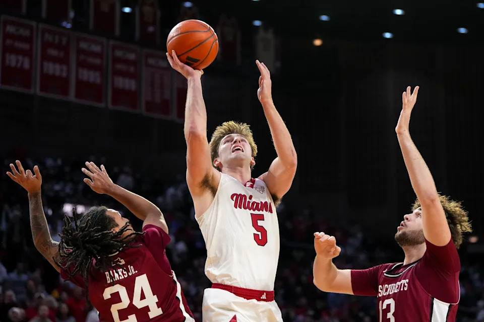 OXFORD, OHIO - JANUARY 27: Peter Suder #5 of the Miami (OH) RedHawks attempts a shot while being guarded by Marcus Banks Jr. #24 and Luka Damjanac #13 of the UMass Minutemen in the second half at Millett Hall on January 27, 2026 in Oxford, Ohio. (Photo by Dylan Buell/Getty Images)