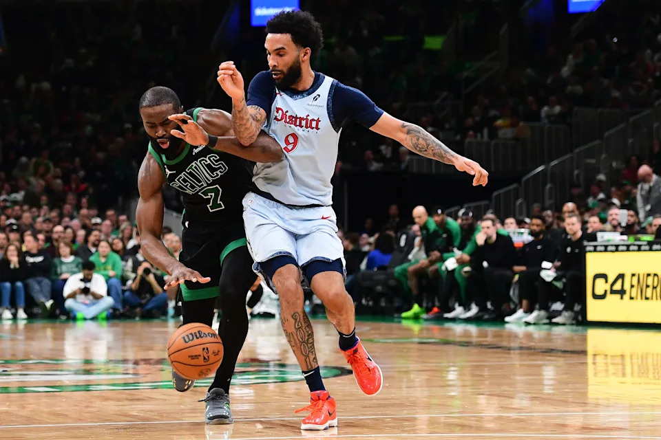 Apr 6, 2025; Boston, Massachusetts, USA; Boston Celtics guard Jaylen Brown (7) runs into Washington Wizards forward Justin Champagnie (9) during the second half at TD Garden. Mandatory Credit: Bob DeChiara-Imagn Images