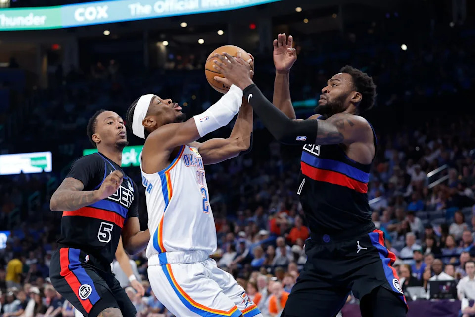 Mar 30, 2026; Oklahoma City, Oklahoma, USA; Oklahoma City Thunder guard Shai Gilgeous-Alexander (2) shoots between Detroit Pistons forward Paul Reed (7) and forward Ronald Holland II (5) during the second half at Paycom Center. Mandatory Credit: Alonzo Adams-Imagn Images
