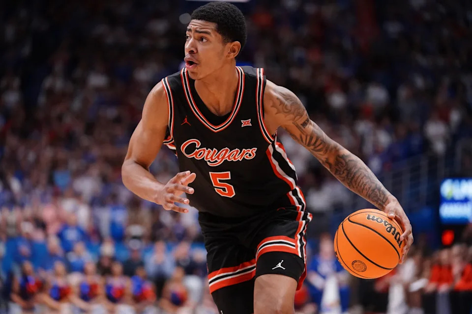 Houston Cougars center Chris Cenac Jr. (5) drives the ball against Kansas Jayhawks during the game inside Allen Fieldhouse on Monday, Feb. 23, 2026.