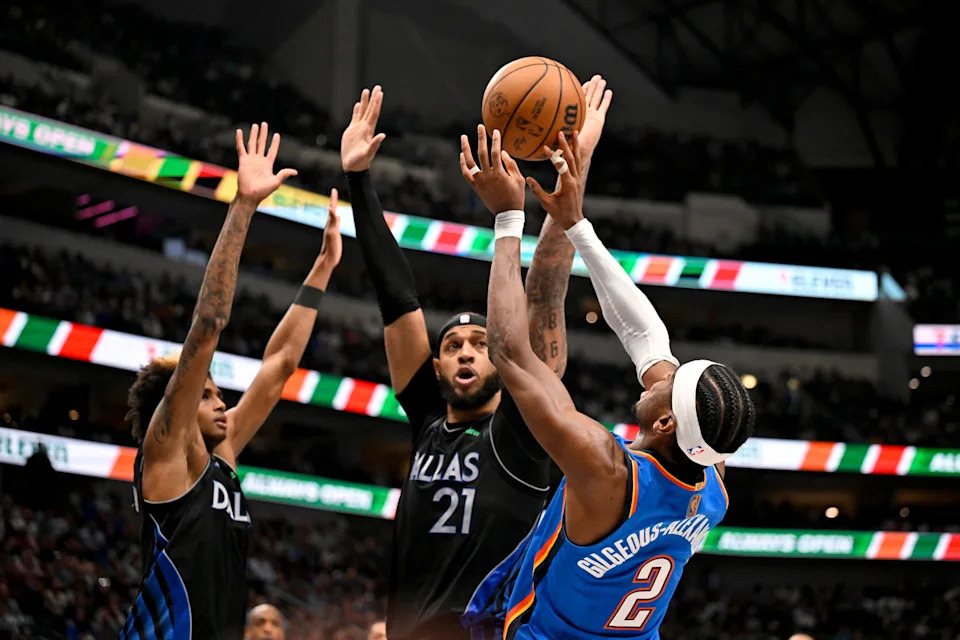 Mar 1, 2026; Dallas, Texas, USA; Oklahoma City Thunder guard Shai Gilgeous-Alexander (2) shoots the ball over Dallas Mavericks guard Max Christie (00) and forward Daniel Gafford (21) during the second half at the American Airlines Center. Mandatory Credit: Jerome Miron-Imagn Images