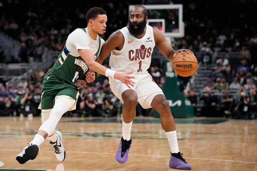 James Harden of the Cleveland Cavaliers dribbles the ball against Ryan Rollins of the Milwaukee Bucks.
