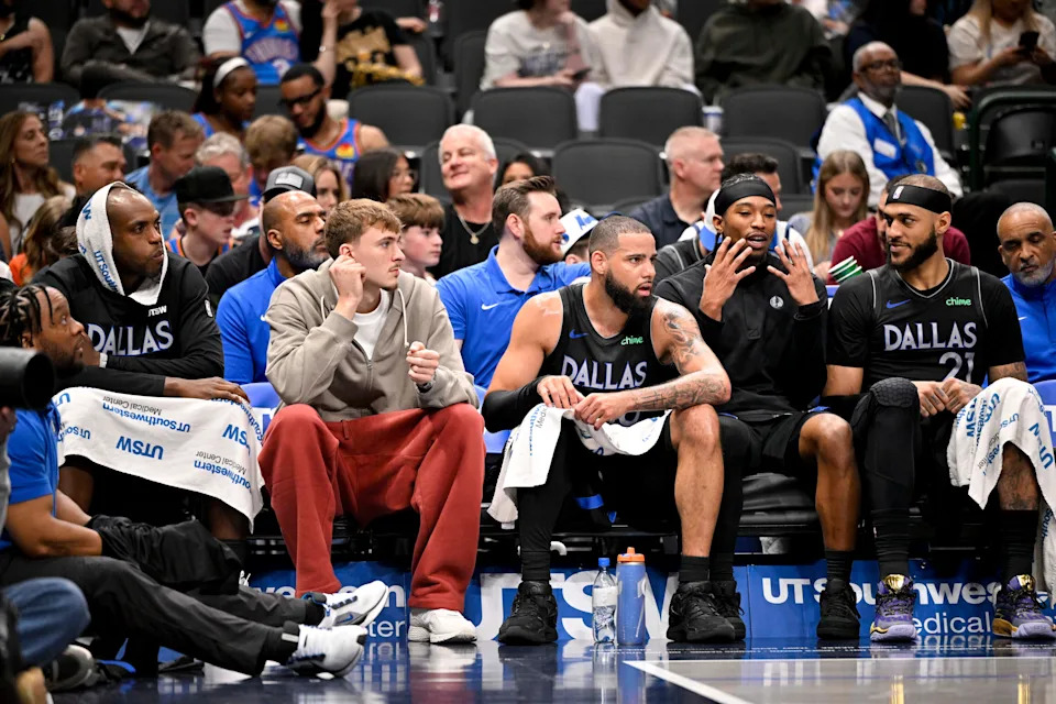 Mar 1, 2026; Dallas, Texas, USA; (from left) Dallas Mavericks forward Khris Middleton (20) and forward Cooper Flagg (32) and forward Caleb Martin (16) and guard Brandon Williams (10) and forward Daniel Gafford (21) look on from the team bench during the second half against the Oklahoma City Thunder at the American Airlines Center. Mandatory Credit: Jerome Miron-Imagn Images