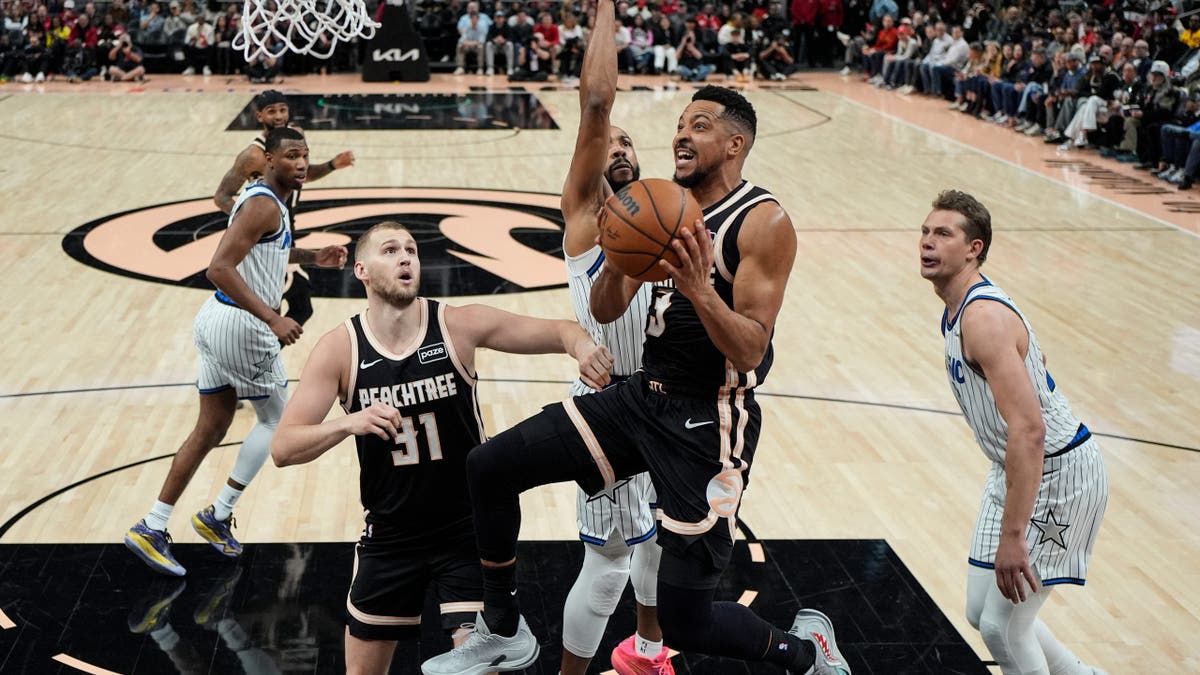 Atlanta Hawks player CJ McCollum drives to the basket